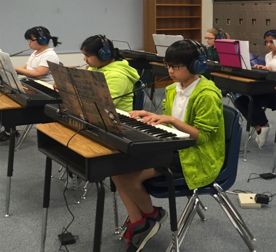 students playing on their pianos