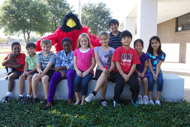Group of 10 students at Kent Elementary with the Cardinal Mascot in the back.