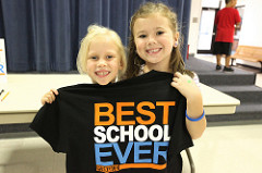 two girls holding a shirt that says best school ever