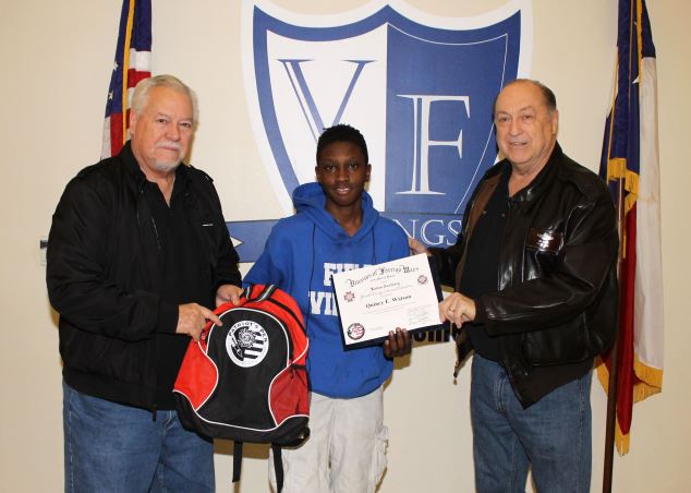 Two men presenting a Field Student with a certificate for Patriots Pen Essay Contest