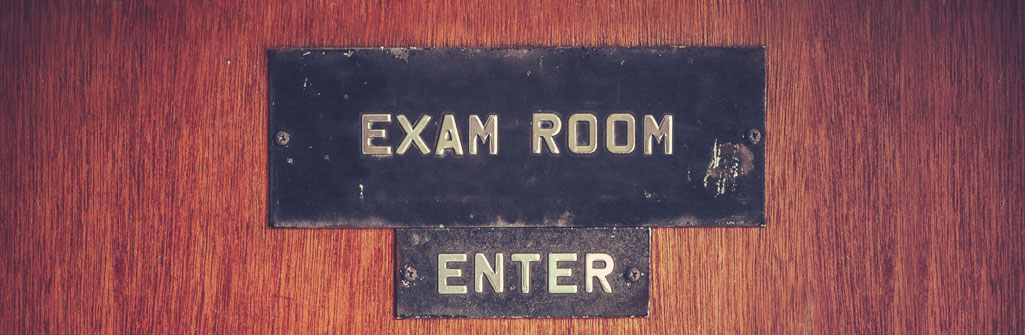 black label with white type saying "Exam Room, Enter"