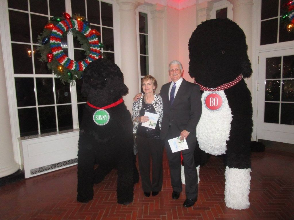 Gretchen Biery & husband Randy at the White House, posing with decorations resembling the first dogs, Sunny & Bo.