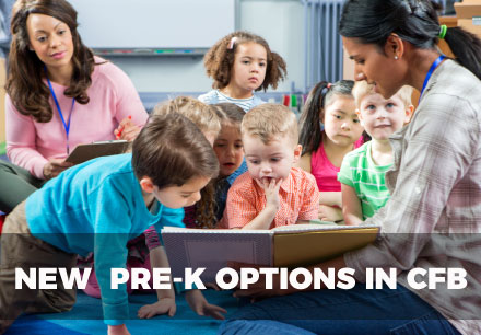 pre-k students interacting with teacher as she reads a book