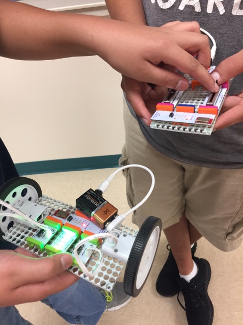 Barbara Bush students use the Little Bits electronic kits to make cars and moving arms.