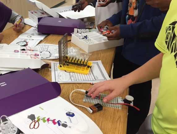 Barbara Bush students use the Little Bits electronic kits to make cars and moving arms.