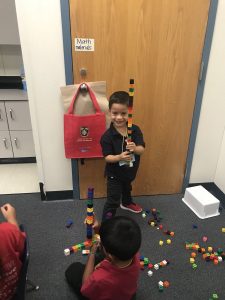 kids create towers with blocks
