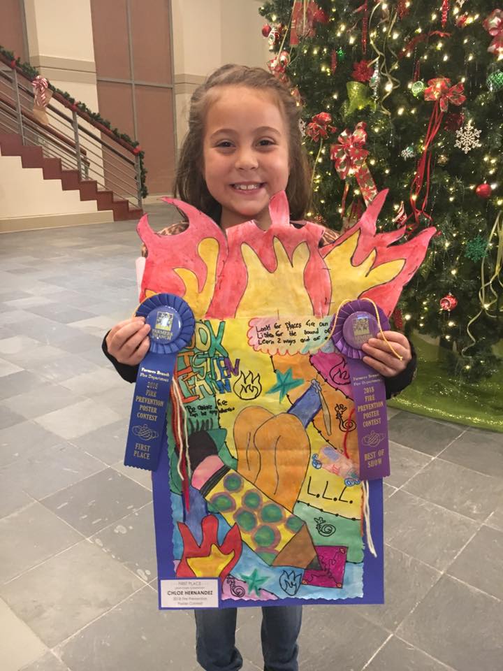 Janie Stark third grader Chloe Hernandez shows off her Fire Prevention Poster, just announced as Best of Show for the 2019 Fire Prevention Poster Contest. The theme of the 2019 poster contest was "LOOK. LISTEN. LEARN. Be aware. Fire can happen anywhere." As winner, Chloe received a $100 gift card to Walmart. This year marked the 23rd consecutive year the Farmers Branch Fire Department has offered the Fire Prevention Poster Contest.