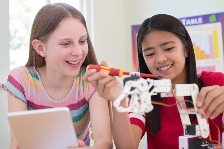 Two Female Pupils In Science Lesson Studying Robotics. Robotic design at the CFBISD STEAM Gifted Academy